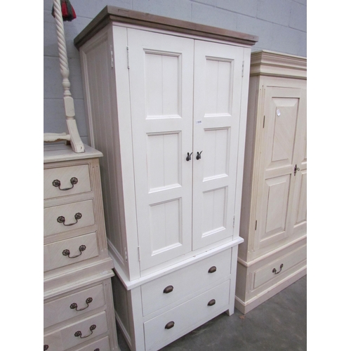 2235 - A white painted wardrobe, two doors over two long drawers set with cup handles