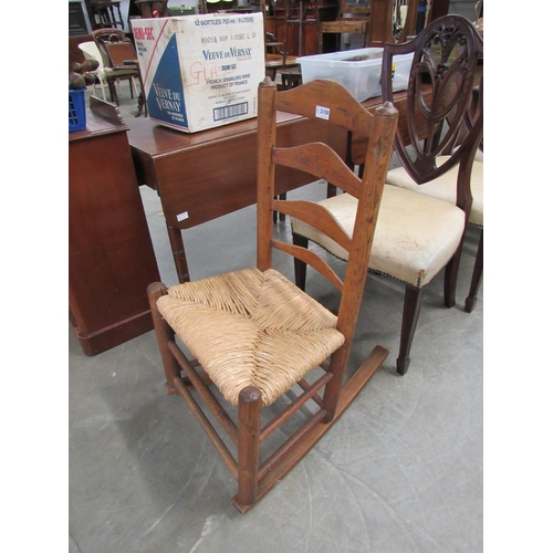 2158 - A 19th Century elm rocking chair with rush seat