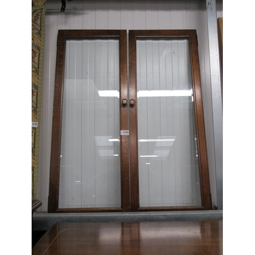 2166 - A pair of oak and glazed cabinet doors with bevelled glass 35 x 91cm