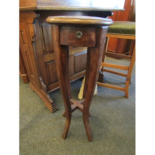 1135 - An eastern hardwood jardiniere stand with circular top and faux drawer, 78cm tall