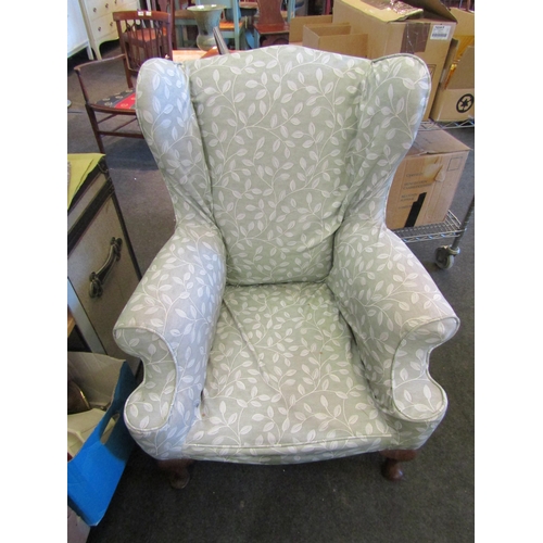 1141 - A Georgian wing back fireside armchair. The scroll arms over oak cabriole fore legs   (R) £30