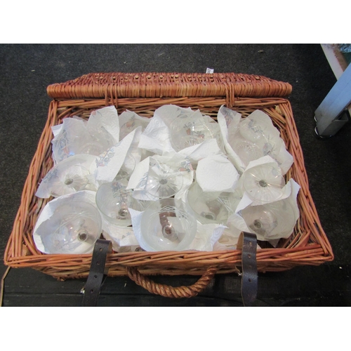 1163 - A wicker basket containing 12 cut glass bowls and 10 wine glasses