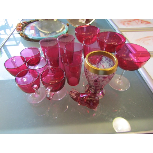 1186 - A selection of cranberry drinking glasses together with a pig figure and vase (16)