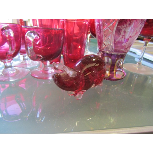 1186 - A selection of cranberry drinking glasses together with a pig figure and vase (16)