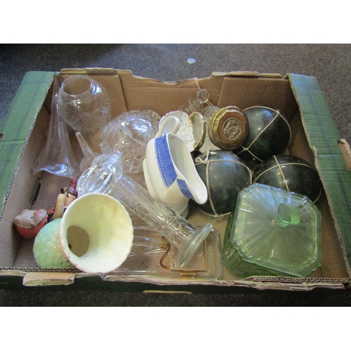 1203 - A box of glassware including a green glass lidded container, decanter etc.