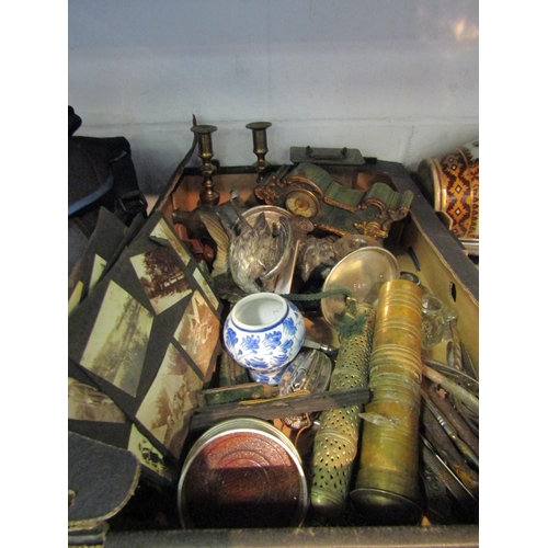 1212 - A box containing mainly metalwares comprising of a pair of brass candlesticks and a plated wine glas... 