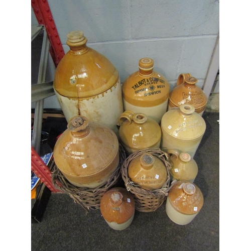 1229 - A group of varying size stoneware jugs including local examples such as Ipswich, Stowmarket and Bury... 