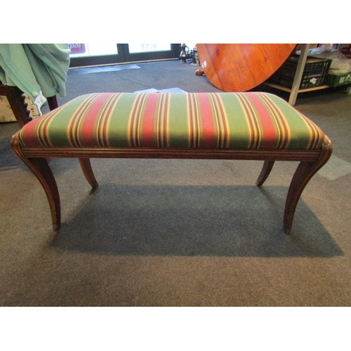 1022 - A regency mahogany duet stool with striped green and pink upholstery