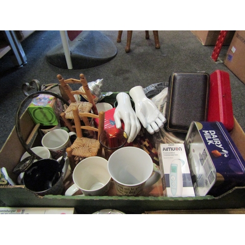 1207 - A box of miscellaneous including mugs, flatware, mannequin hands, tins, etc