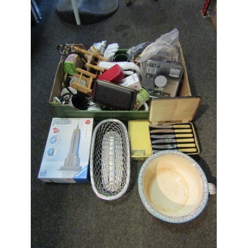 1207 - A box of miscellaneous including mugs, flatware, mannequin hands, tins, etc