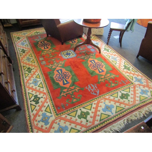 1472 - A large Turkish wool floor rug with tribal decorative borders and tasselled ends. 340cm x 217cm