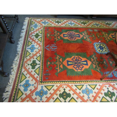 1472 - A large Turkish wool floor rug with tribal decorative borders and tasselled ends. 340cm x 217cm