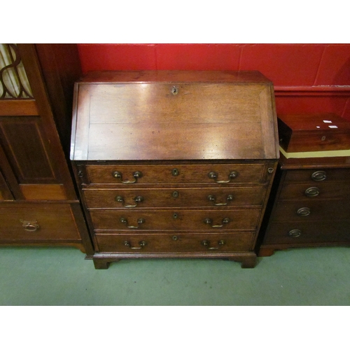 4067 - A George III provincial oak bureau, the fully fitted interior of eight drawers, central cupboard and... 