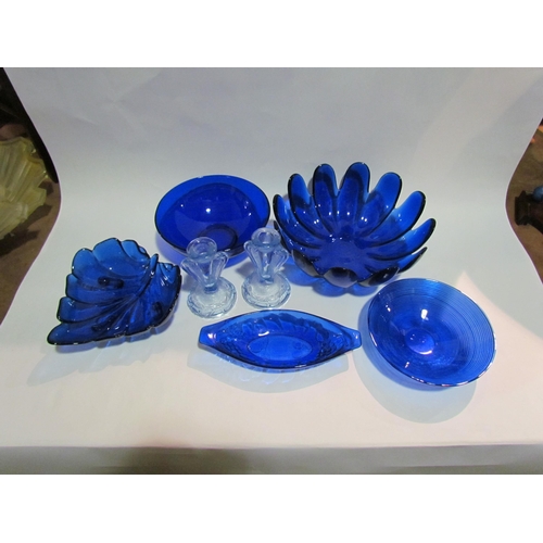 4182 - A collection of blue glass bowls together with a pair of blue pressed glass candlesticks (7)