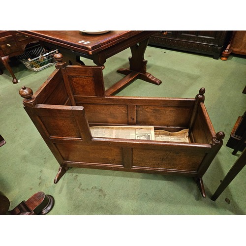 4215 - An 18th Century panelled oak cradle/log box with turned finial decoration on sledge foot end support... 