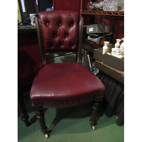 4002 - A 19th Century mahogany chair, red leather seat and button back, turned fore legs to white ceramic c... 