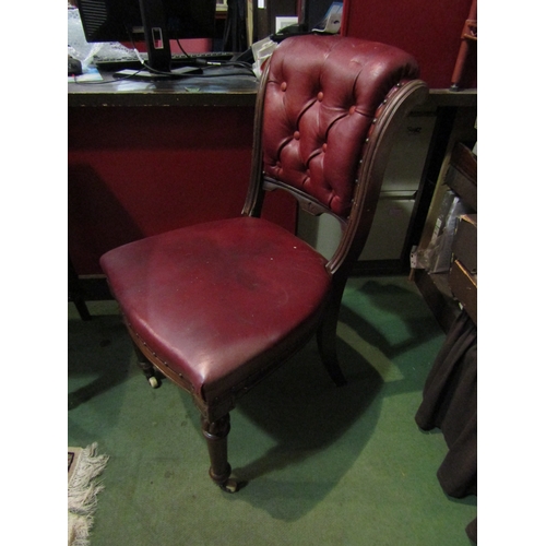 4002 - A 19th Century mahogany chair, red leather seat and button back, turned fore legs to white ceramic c... 