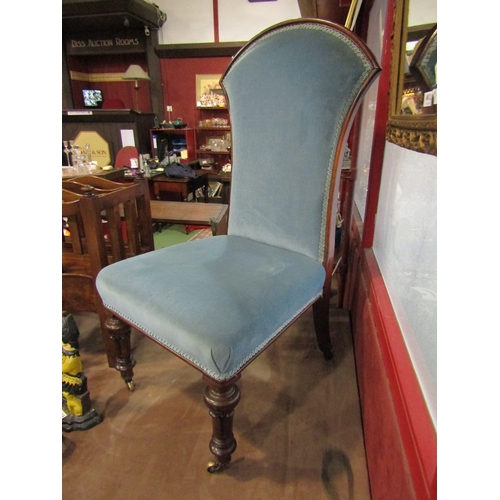 4010 - A blue upholstered chair on castors