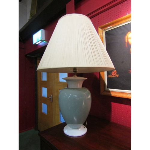 4024 - A large bulbous two tone porcelain lamp base with tasselled shade