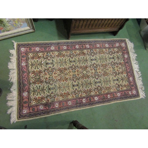 4465 - A Persian style rug, the cream ground decorated with floral designs and multiple borders with tassel... 