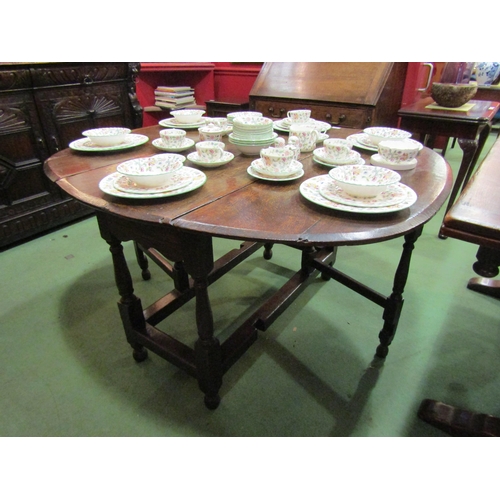 4072 - A country oak gateleg dining table on turned supports, 74cm tall x 130cm x 123cm   (E) £30-50