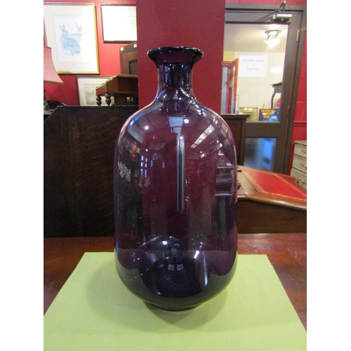 4079 - An amethyst glass vase, 35cm tall