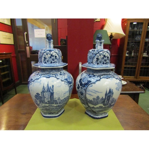 4101 - A pair of 20th Century Continental blue and white vases, one lid a/f