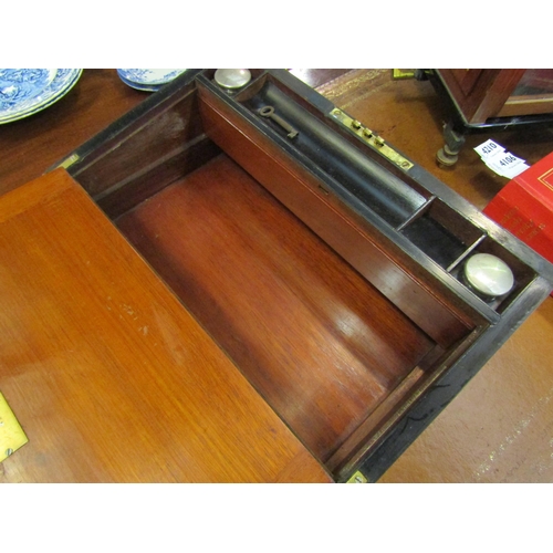 4107 - A late 19th Century walnut writing box with brass plaque and banding, inkwells and keys