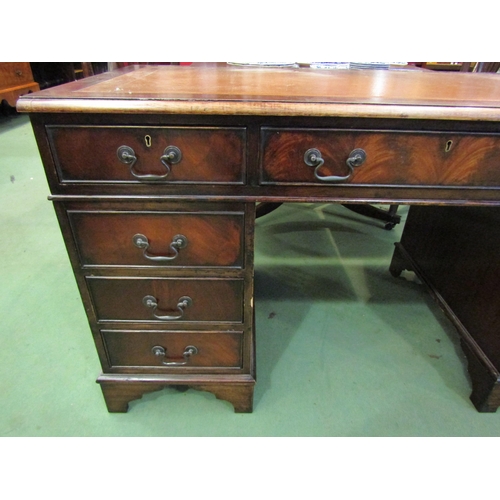 4108 - A leather topped twin pedestal eight drawer desk, 76cm tall x 134cm wide x 68cm deep