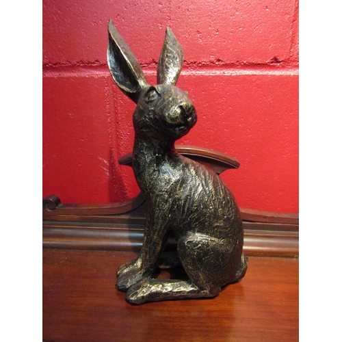 4138 - A bronzed effect figure of a seated hare, 25.5cm tall