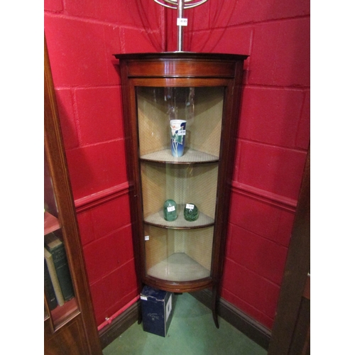 4153 - An Edwardian inlaid mahogany bow front vitrine, the single glazed door with key, over outswept taper... 