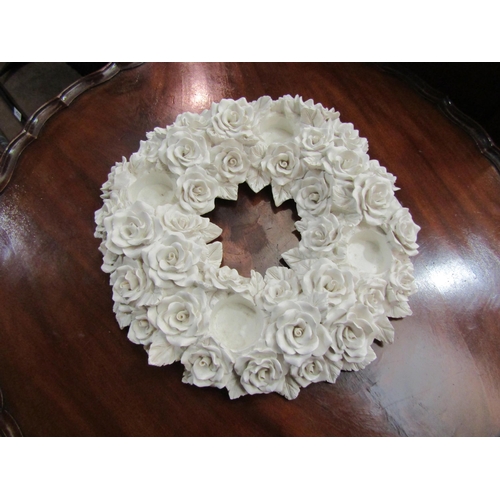 4218 - A white circular candle centrepiece of floral design, 32cm diameter