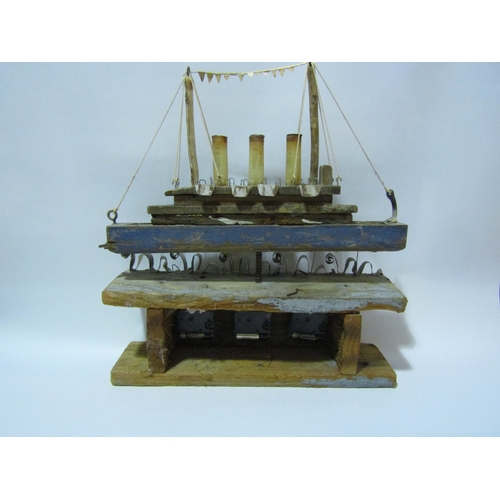 4295 - A rustic driftwood effect model of a steamer boat with clock dials, 46cm tall