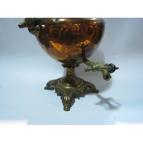 4300 - A copper samovar with animals head handles, 45cm tall, together with a copper kettle