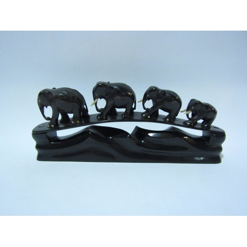 4305 - An ebony elephant family on stand, 30cms long