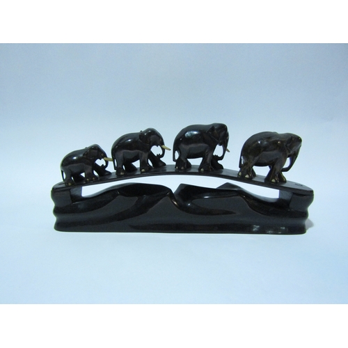 4305 - An ebony elephant family on stand, 30cms long