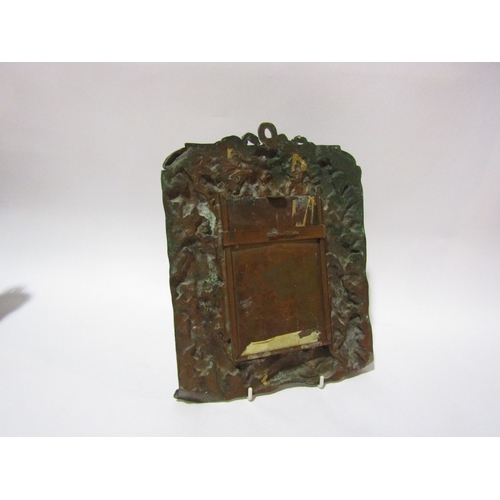 4313 - A copper wall mirror, heavily embossed with recumbent female and cherubs, 27cm x 22cm, brass letter ... 