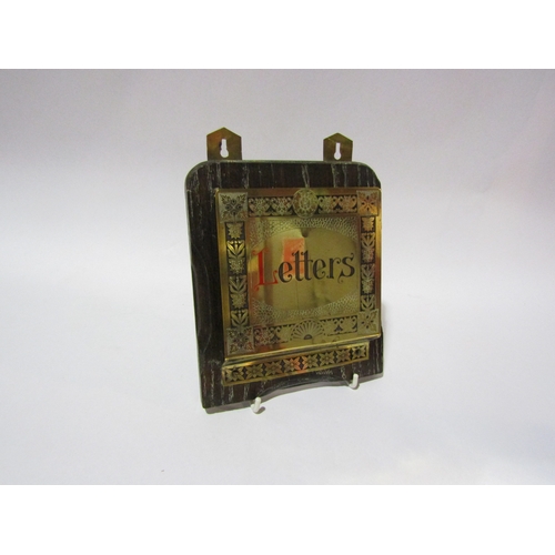 4313 - A copper wall mirror, heavily embossed with recumbent female and cherubs, 27cm x 22cm, brass letter ... 