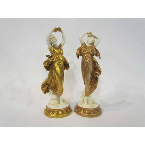 4333 - A near pair of continental Naples porcelain figures of ladies wearing gilt robes, 20cm tall