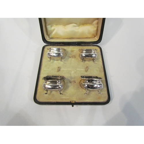 4346 - A cased set of four silver salts raised on four feet, Birmingham (minus glass liners and spoons)