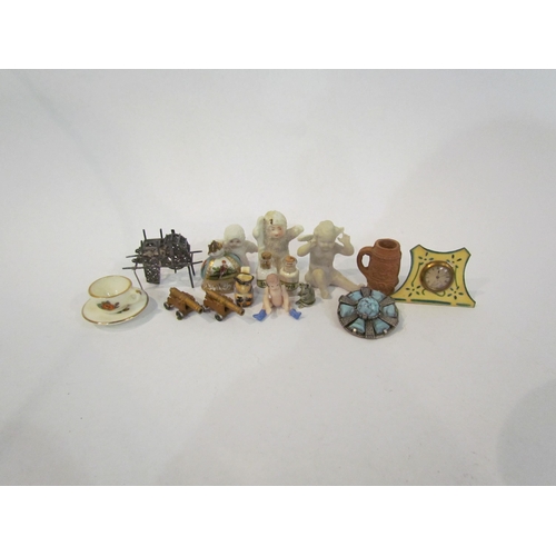 4353 - A selection of miniature ornaments including figure, clock, canons, articulated doll, salt and peppe... 