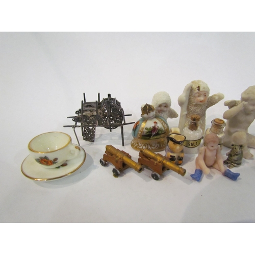 4353 - A selection of miniature ornaments including figure, clock, canons, articulated doll, salt and peppe... 