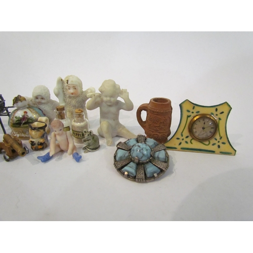 4353 - A selection of miniature ornaments including figure, clock, canons, articulated doll, salt and peppe... 