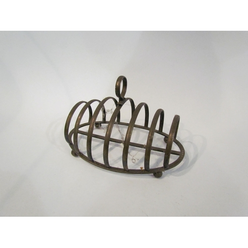 4364 - A silver seven bar toast rack, on ball feet, marks indistinct