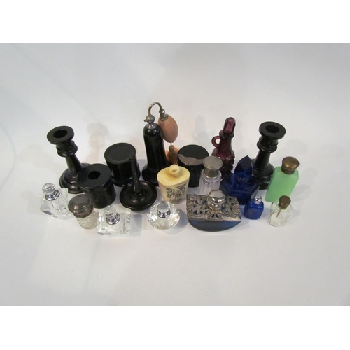 4368 - A collection of perfume bottles and an ebony dressing table set (some with silver tops)