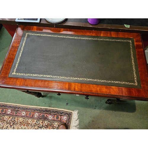 4001 - A Victorian mahogany round cornered writing table, the gilt tooled leather writing surface over two ... 