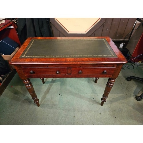 4001 - A Victorian mahogany round cornered writing table, the gilt tooled leather writing surface over two ... 