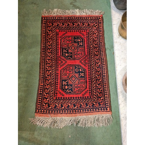 4175 - An Afghanistan wool rug, red ground with multiple borders, tasselled ends, 100cm x 64cm