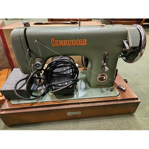 4202 - A singer hand crank sewing machine together with a Commodore electric exmple, both cased