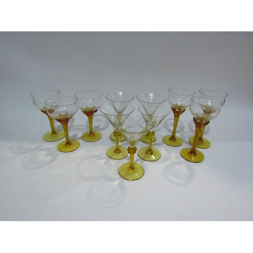 4404 - A set of six wine glasses with amber twisted stems and five cocktail glasses with amber stems